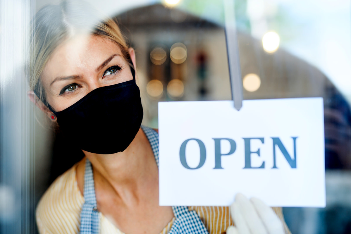 Coffee shop woman owner with face mask