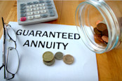 Guaranteed Annuity with coins on paper