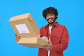 young man holding open parcel box isolated on blue background