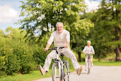 happy senior couple riding bicycles