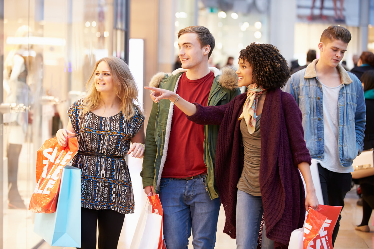 Young Friends Shopping In Mall