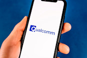 hand holds smartphone with qualcomm logo
