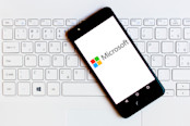 Microsoft Corporation logo is displayed on a smartphone