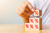 Hand putting wood cube block increasing on top