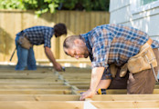 Side view of mid adult carpenters working at construction site