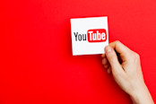 Hand holding YouTube logo