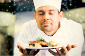 chef with eyes closed smelling food