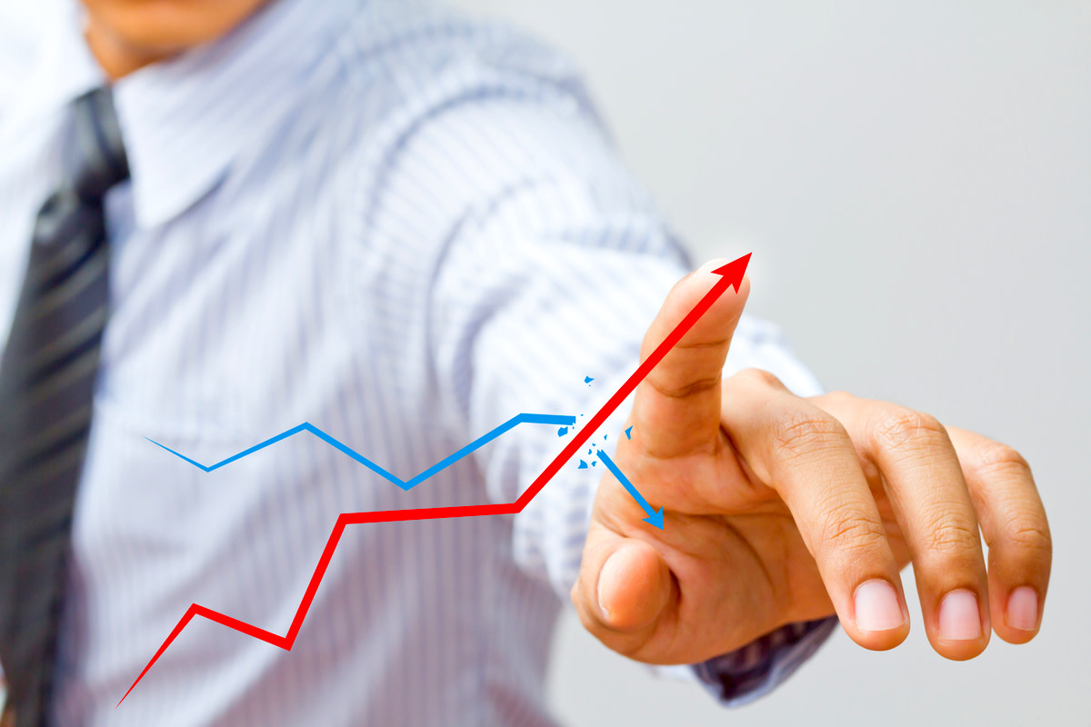 Businessman drawing a rising arrow