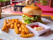 Hamburger, french fries, mayonnaise and ketchup on restaurant background