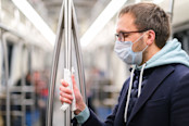 Close up of man holds a handrail in public transport