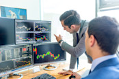 Stock brokers looking at graphs