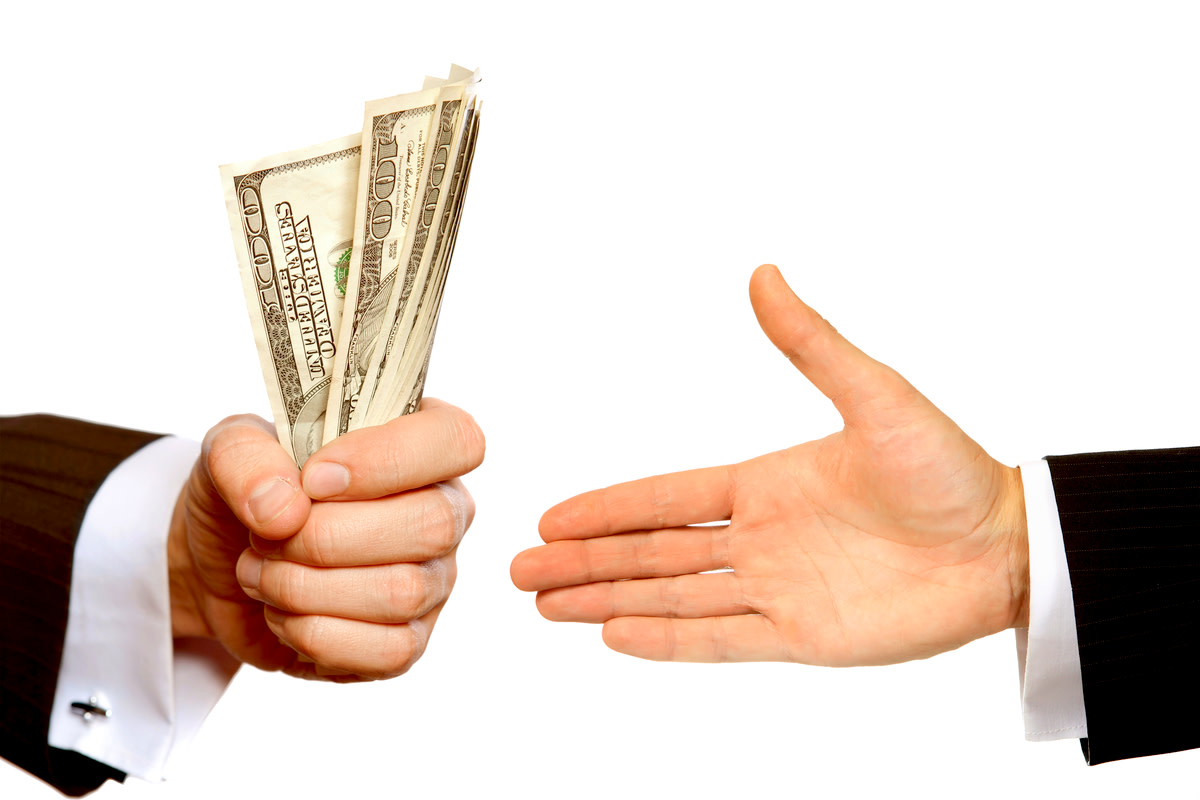 Hand handing over money to another hand