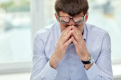 tired advisor with eyeglasses in office