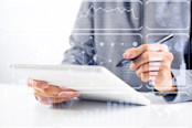 Investor working with financial information at tablet computer