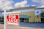 Vacant Retail Building with For Lease Real Estate Sign