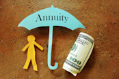 Annuity umbrella over a paper cutout person