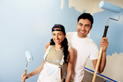 Portrait of smiling couple with paint rollers
