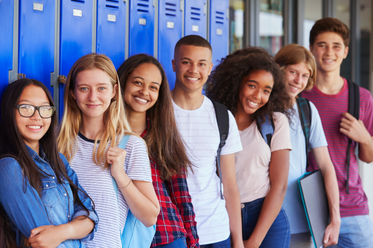Students standing together in front of their lockers. Students standing together in front of their lockers.