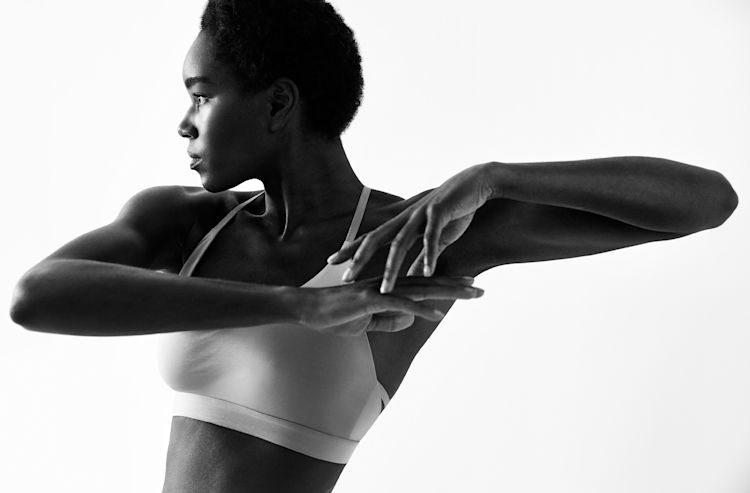 Mirror-Interactive-Gym-Black-And-White-Woman-Stretching-Lifestyle-Photo