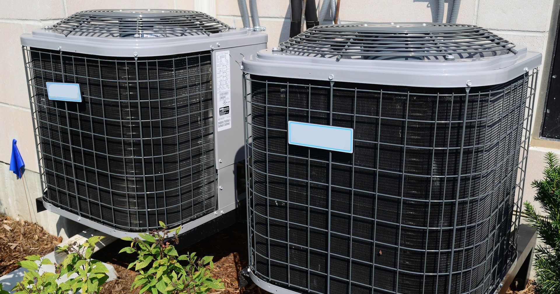 Two unmarked HVAC units installed by an HVAC business