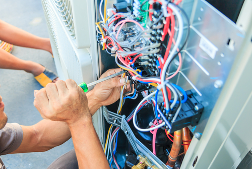 HVAC technician working on wires