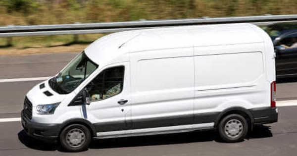 White plumbing van driving