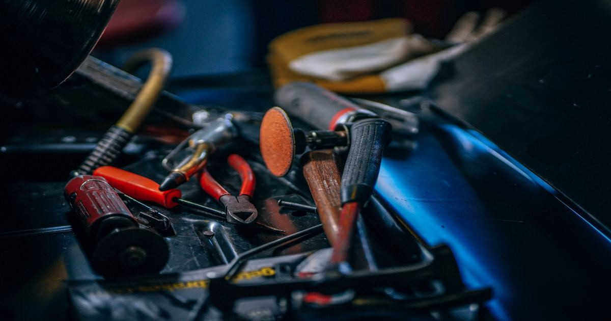 Series of HVAC tools laying on a hard surface.
