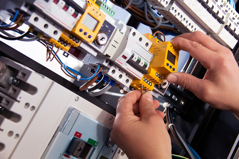 Electrician Working On A Circuit Board With Yellow Circuit