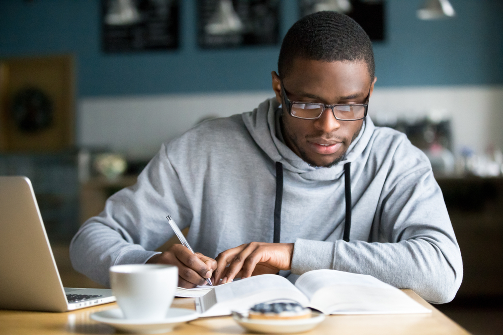 Man Sitting While Studying for an Exam