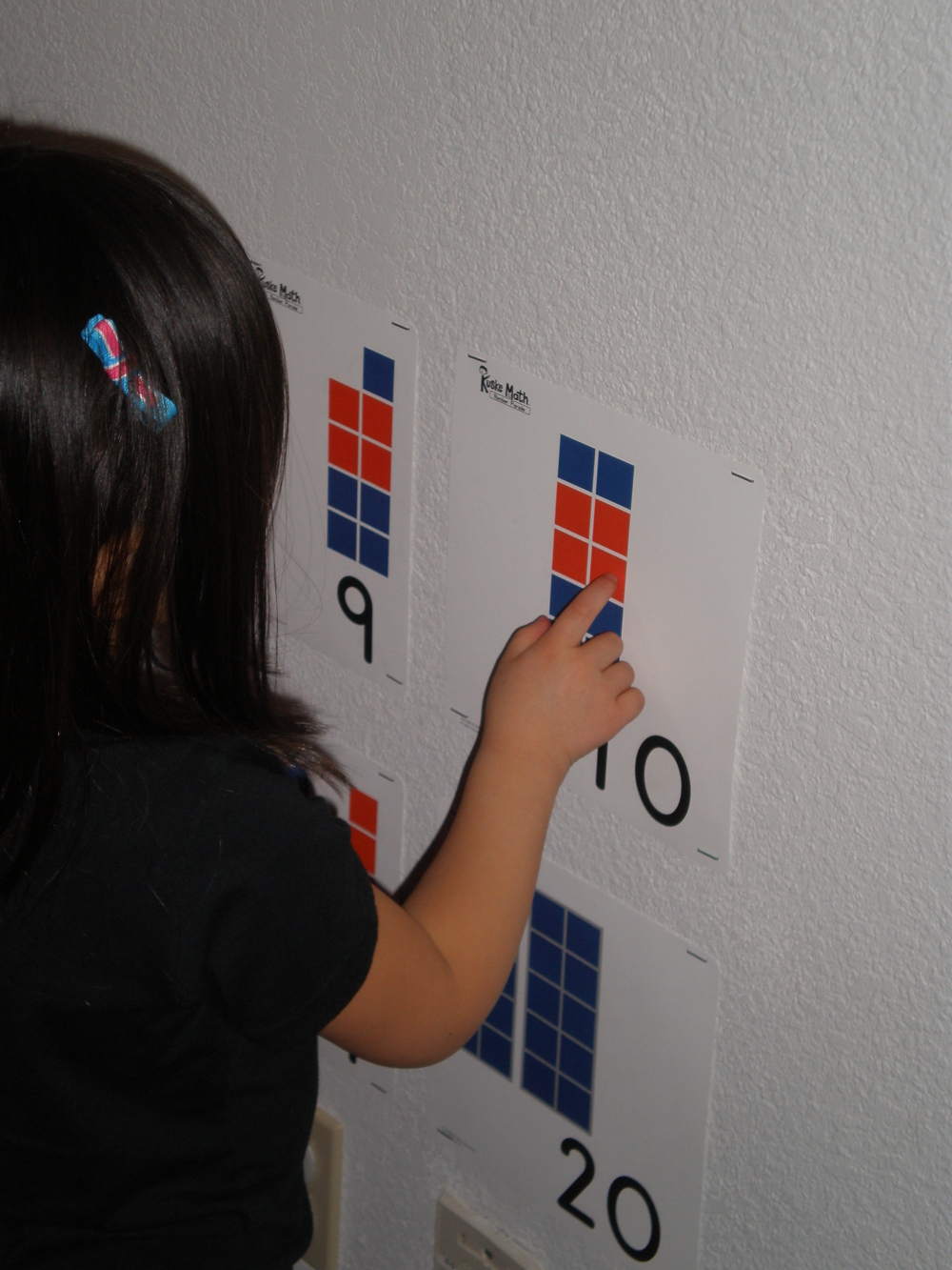 Girl pointing to ten on the number parade