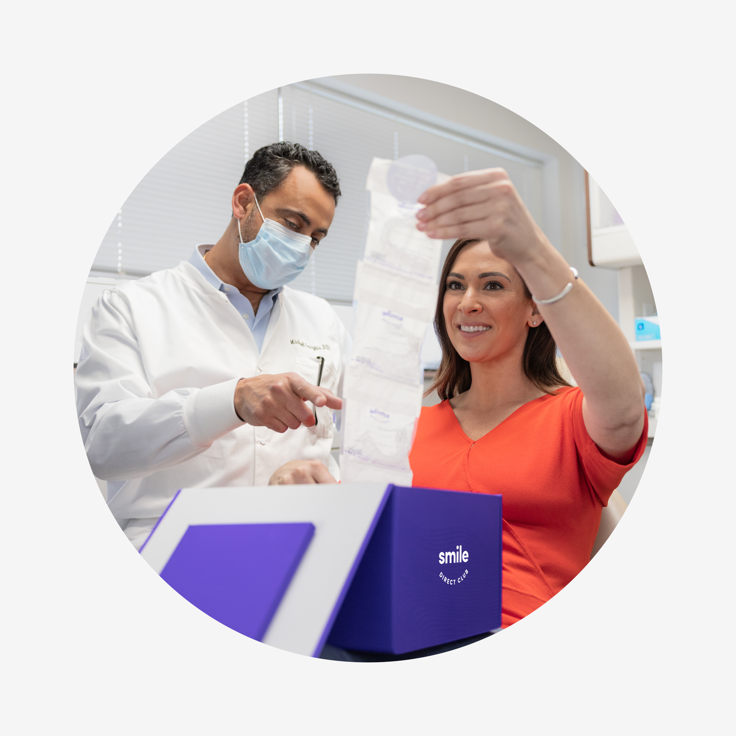 SmileDirectClub Doctor with patient pulling aligners out of her blurple aligner box