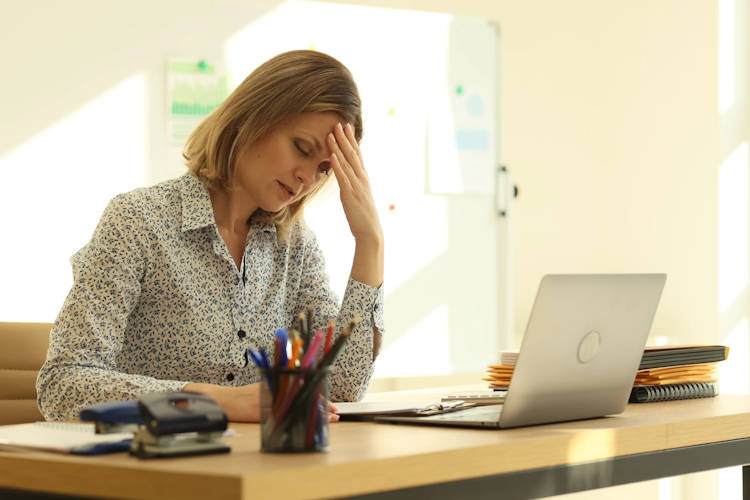 Tired woman during work at the laptop