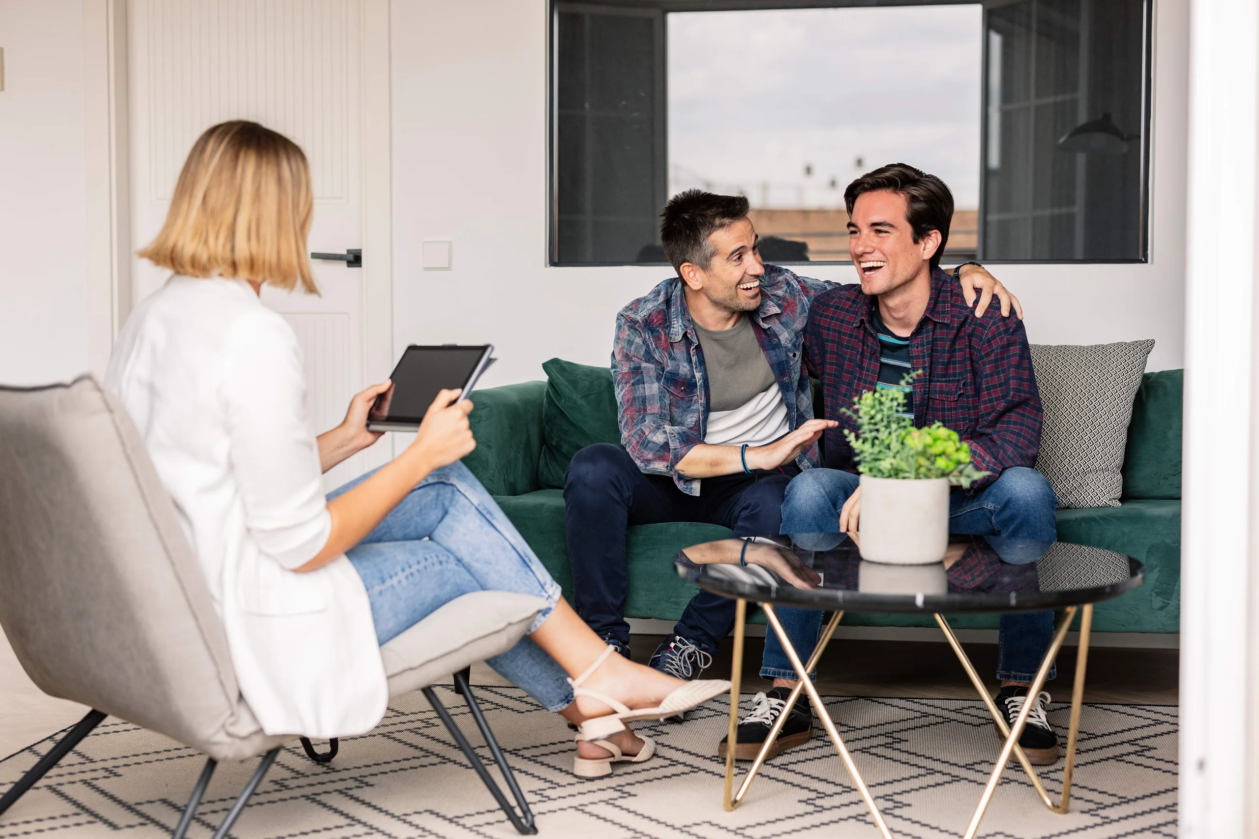 A woman is consulting 2 men
