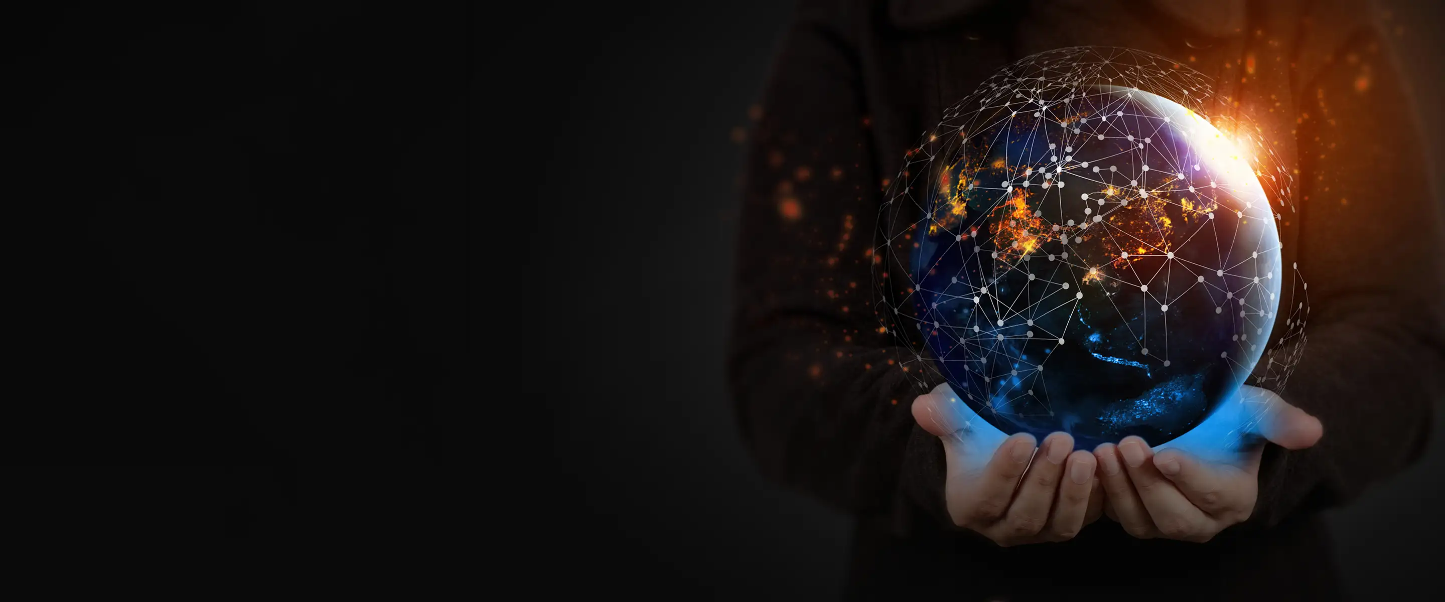 A person holding a glowing, digital planet Earth. The globe is illuminated with warm orange lights and glowing blue highlights, encased in a geometric overlay of connected white network lines and dots representing global technology and communication.