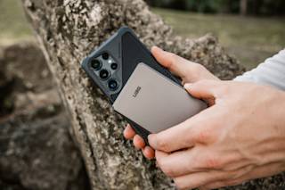 UAG SRGE Slim 5K Power Bank Portable Charger case in Black/Grey lifestyle view