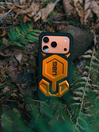 UAG Exclusive Monarch Pro iPhone 17 Pro Max Case iPhone 17 Pro Max in Orange lifestyle view