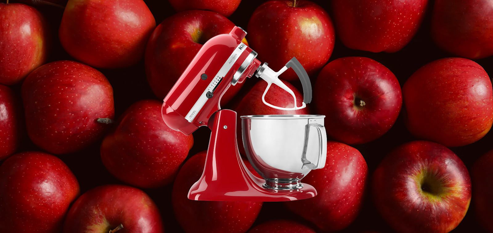 Red KitchenAid® stand mixer set against a background of red apples
