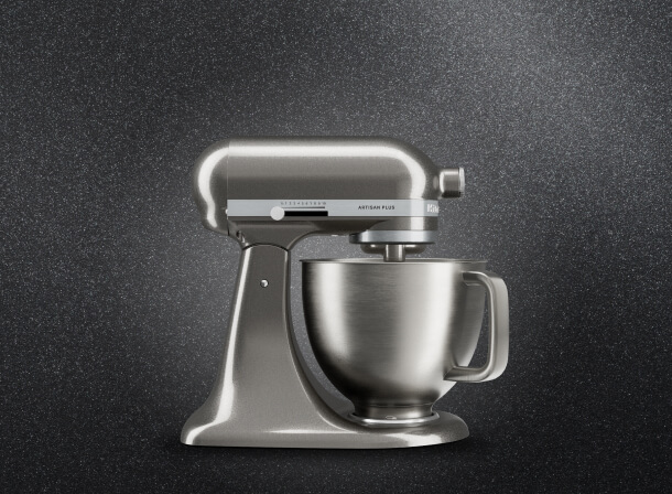 Side view of a silver KitchenAid® stand mixer against a dark background