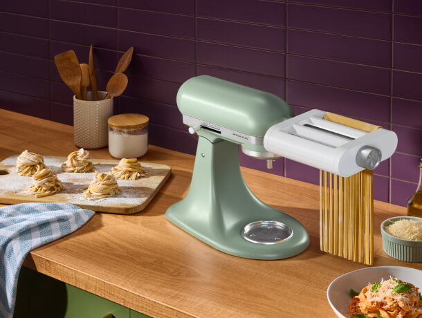 A KitchenAid® stand mixer with a pasta attachment