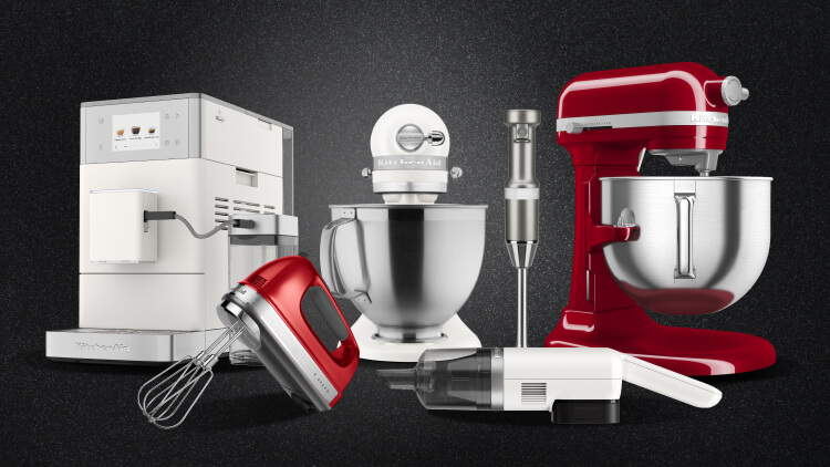 KitchenAid® countertop appliances in assorted colors on a textured dark background.