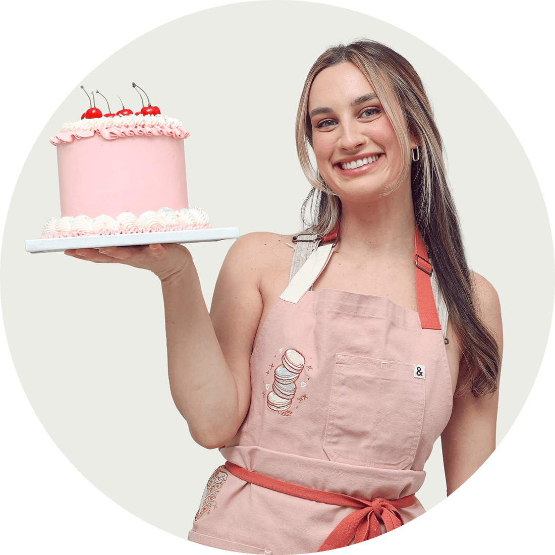 Mackenzie Lee holding a cake