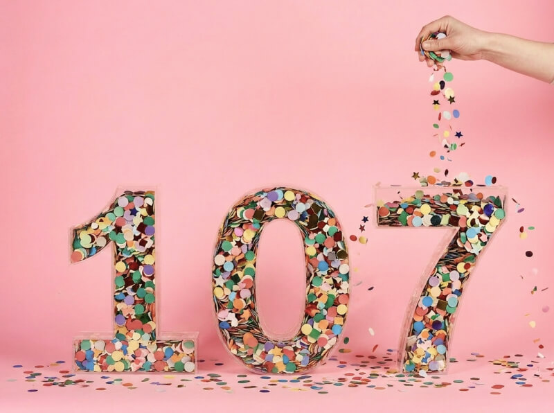 Containers in the shape of the number 107 and filled with confetti.