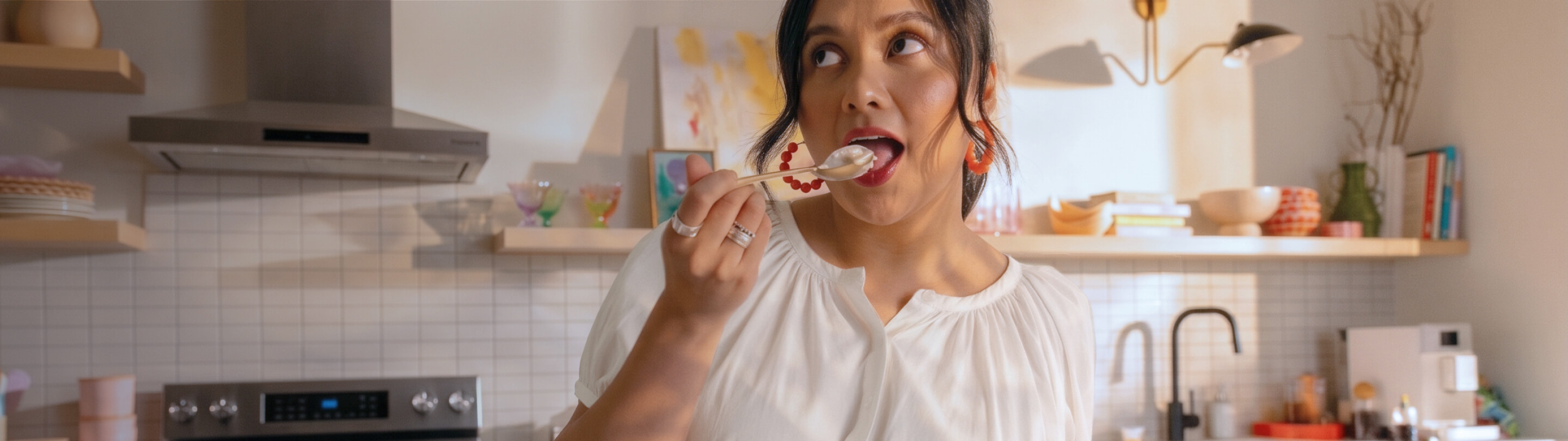 A woman tasting homemade ice cream with a spoon
