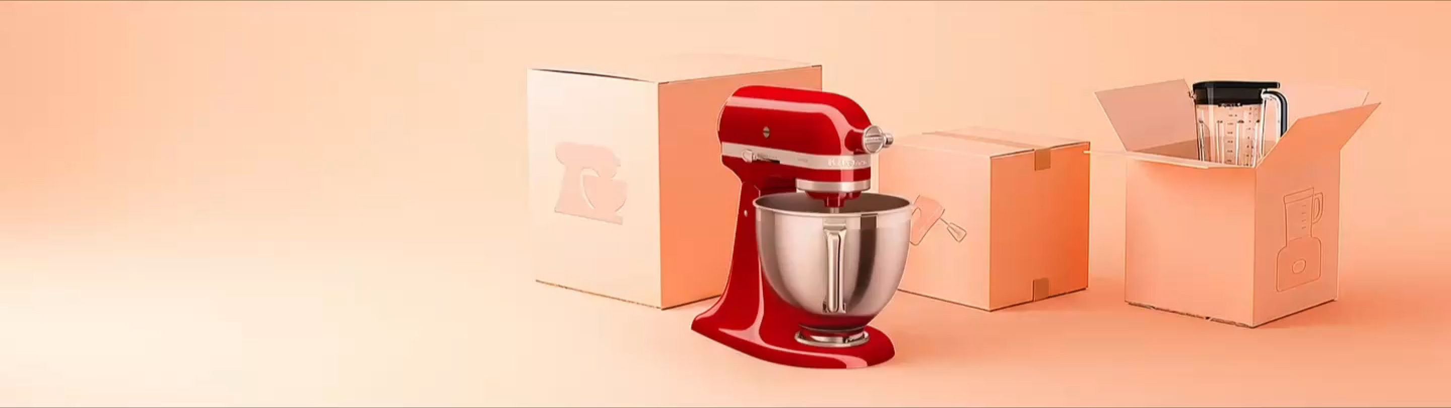 A video of confetti falling over a KitchenAid stand mixer, blender and unopened boxes.