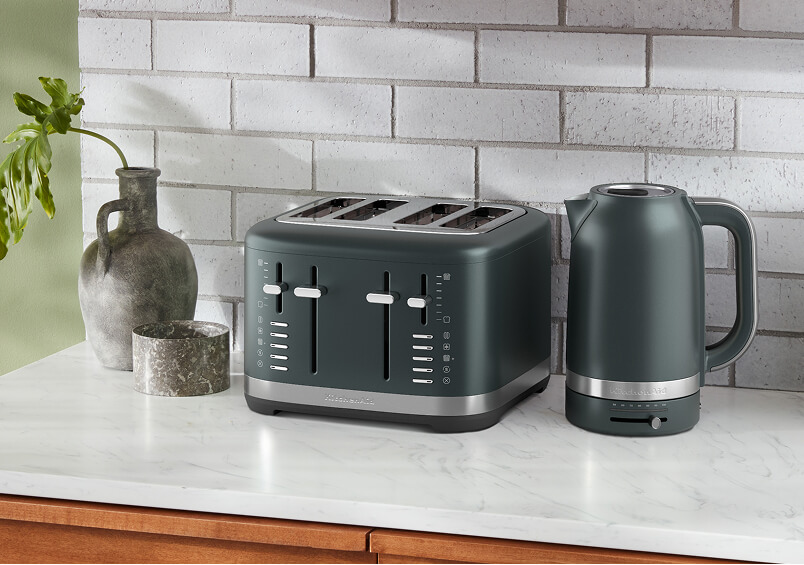 A green KitchenAd® toaster and kettle