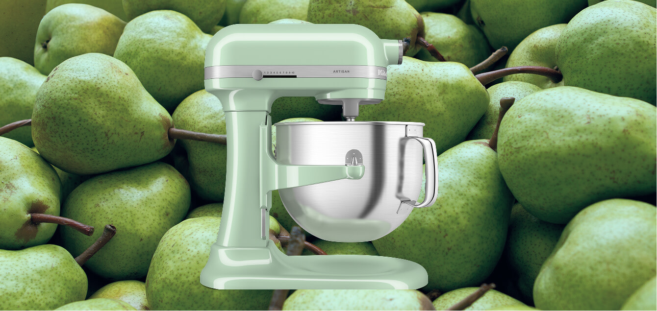 Green KitchenAid® stand mixer set against a background of green pears