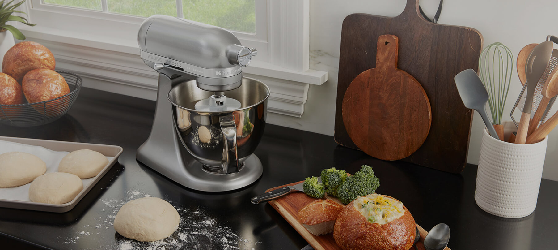 A KitchenAid® stand mixer and baking ingredients