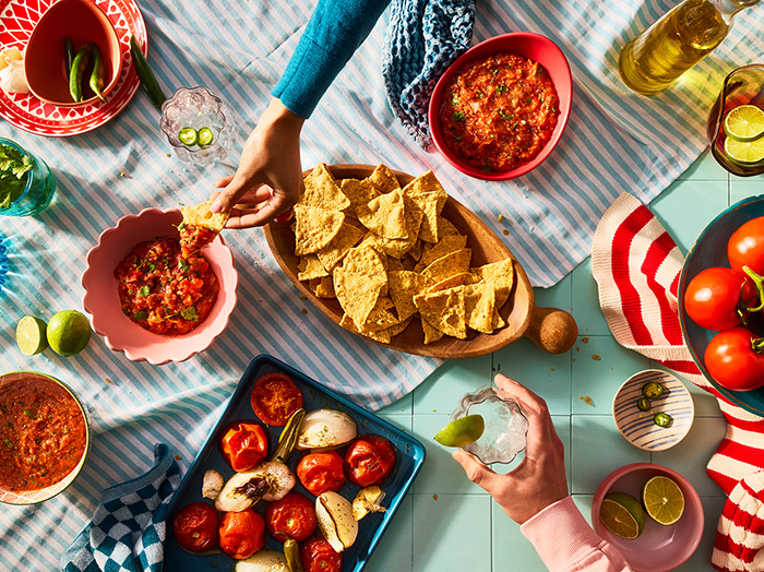 An array of food laid out on a picnic blanket