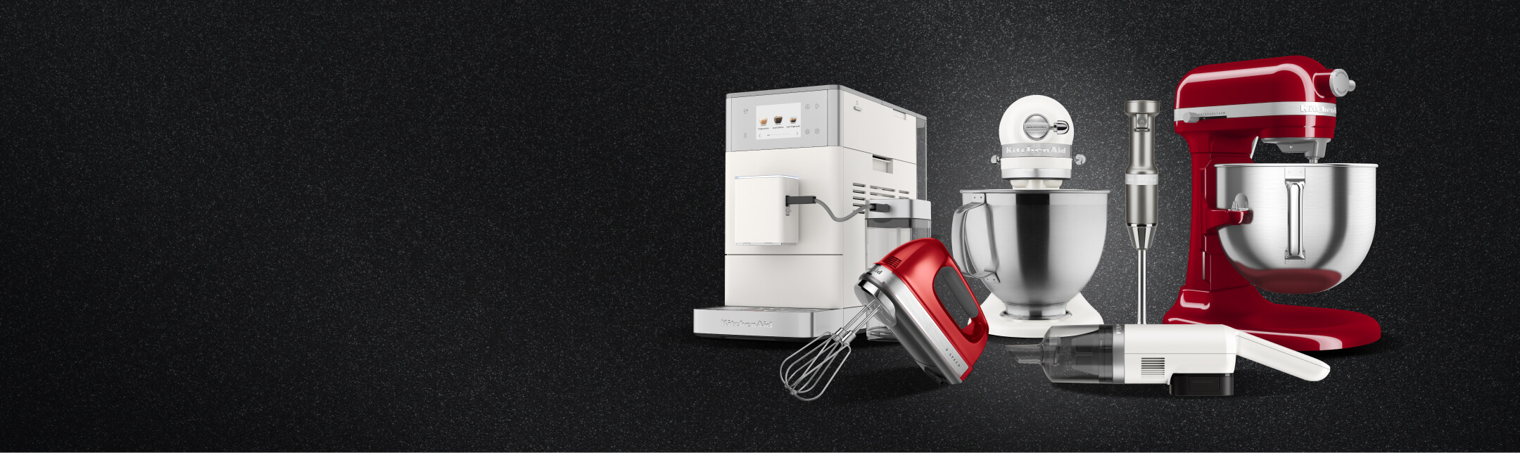 KitchenAid® countertop appliances in assorted colors on a textured dark background.