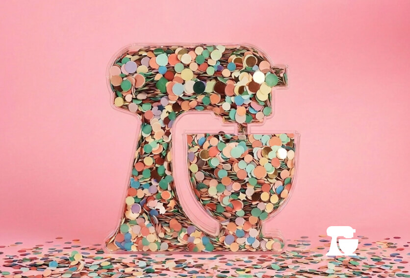 A container in the shape of a KitchenAid® stand mixer full of confetti.